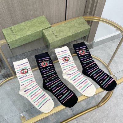 A box of four pairs of Gucci GG limited edition shoes with packaging. Gucci's GG