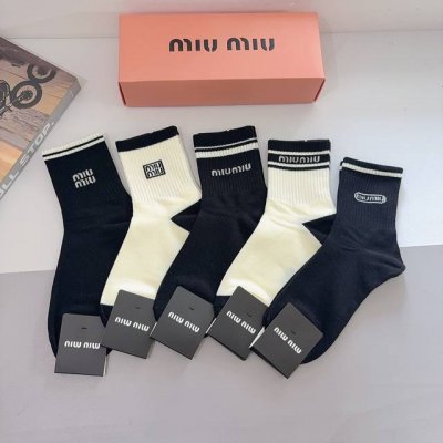 A box of 5 pairs of Miumiu men's mid-calf socks with packaging. Made of pure cot