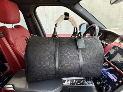 A new high-end Coach Keepall 50 travel bag with a monogram-embossed leather duff