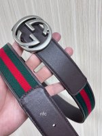 This double-sided belt features red and green webbing and dark brown cowhide lea