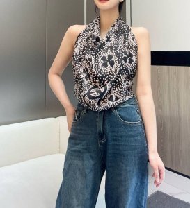 is a rare vintage Chanel silk scarf, featuring a clever pattern of white polka