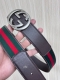 This reversible belt features red and green webbing and dark brown cowhide leath