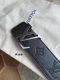 Fashionable Louis Vuitton belt. Black leather embossed belt with lettering metal