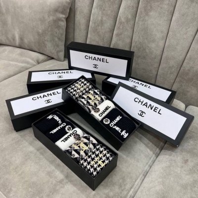 Packaged as a box of five pairs of Chanel mid-calf socks. Sizes 35-40. Material
