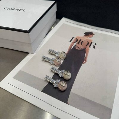 A pair of Chanel's latest diamond-patterned hair clips with packaging box. Super