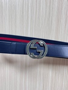 This reversible belt features red and blue webbing and blue cowhide leather, pai